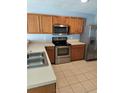 Bright kitchen with stainless steel appliances and ample countertop space at 4321 Winding River Way, Land O Lakes, FL 34639