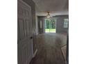 View of living room featuring sliding glass doors, gray walls, and modern flooring at 4321 Winding River Way, Land O Lakes, FL 34639
