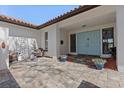 Inviting front entrance with light blue double doors, tiled courtyard and quaint fountain at 4901 Lansing St Ne, St Petersburg, FL 33703