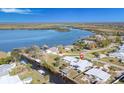 Expansive aerial view showcasing the riverfront property, including boatlifts, seawall, and nearby water access at 541 Ridgecrest Dr, Punta Gorda, FL 33982