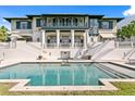 Stunning exterior featuring a pool, beautiful architecture, and an outdoor staircase at 72 Adalia Ave, Tampa, FL 33606