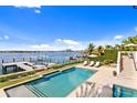 A luxury backyard with a pool, patio furniture, and incredible dock views at 72 Adalia Ave, Tampa, FL 33606