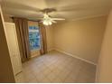 Bedroom featuring neutral walls, ceiling fan, and tiled floors at 7425 Riverbank Dr, New Port Richey, FL 34655