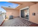 Spacious back porch featuring brick pavers, air conditioning unit and sliding glass doors at 10467 Larchmont N Pl, Pinellas Park, FL 33782