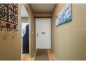 Bright hallway featuring neutral walls, light wood floors, and an arched entryway at 1273 Mission Cir, Clearwater, FL 33759