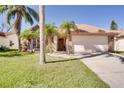 Single-story home has beautiful landscaping with palm trees enhancing its curb appeal, and a two-car garage at 1731 Elk Spring Dr, Brandon, FL 33511