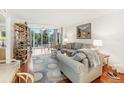 Bright living room with hardwood floors, neutral decor, and view of lake at 1800 Mariner Dr # 9, Tarpon Springs, FL 34689