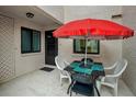 Private patio area with table, chairs, and shade umbrella at 1800 Mariner Dr # 9, Tarpon Springs, FL 34689