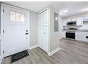Bright foyer featuring durable floors, a closet, and a view of the beautifully renovated kitchen at 1884 Clearbrooke Dr # 1884, Clearwater, FL 33760