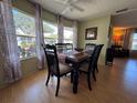 Cozy dining room featuring a wood table, six chairs, and large windows at 2331 Belleair Rd # 527, Clearwater, FL 33764