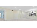 Bright living space features tile floors, recessed lighting, and neutral color palette with kitchen and bathroom access at 2400 Feather Sound Dr # 214, Clearwater, FL 33762