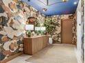 Stylish hallway showcasing decorative wallpaper, wooden console table, and contemporary lighting fixtures at 2912 W Santiago St # 1504, Tampa, FL 33629