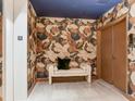 Elegant hallway with decorative wall coverings, bench seating, and modern apartment number plaques at 2912 W Santiago St # 1504, Tampa, FL 33629