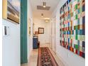 Inviting hallway featuring colorful artwork, chic furnishings, and neutral wall colors at 2912 W Santiago St # 1504, Tampa, FL 33629
