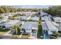Community aerial view of the many homes, manicured landscaping and carports at 37042 Lois Ave, Zephyrhills, FL 33542