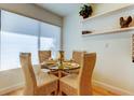 Cozy dining area with glass table and four rattan chairs, complemented by natural light at 6290 Bahia Del Mar Cir # 5, St Petersburg, FL 33715