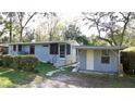 Cozy home with a screened porch, adjacent carport, and walkway to the front entrance at 7043 Lang St, Brooksville, FL 34601