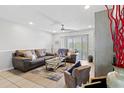 The open-concept living room features a large seating area, modern decor, and ample natural light at 7210 N Manhattan # 1822, Tampa, FL 33614