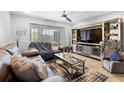 The spacious living room is complete with stylish decor, comfortable seating, and a ceiling fan at 7210 N Manhattan # 1822, Tampa, FL 33614