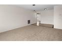 Inviting carpeted living room with tile flooring transitions seamlessly into the next room, offering a bright and open layout at 8460 Calais N # 8406, Pinellas Park, FL 33781