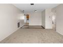 Inviting carpeted living room with tile flooring transitions seamlessly into the kitchen and other rooms, offering a bright and open layout at 8460 Calais N # 8406, Pinellas Park, FL 33781