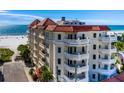 Exterior view of a condo showcasing multiple balconies and architectural details with beach access at 14 Somerset St # 5C, Clearwater, FL 33767