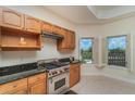 Gourmet kitchen with a stainless steel Wolf range, granite countertops and bright windows at 14 Somerset St # 5C, Clearwater, FL 33767