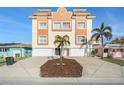 Stunning multi-story home with colorful accents, garages, landscaping and tile roof at 146 175Th Terrace E Dr, Redington Shores, FL 33708