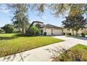 Charming single-Gathering home featuring a well-kept lawn and a three-car garage at 15721 Starling Water Dr, Lithia, FL 33547