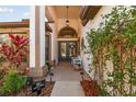 Inviting front entry with decorative accents and a cozy seating area at 15721 Starling Water Dr, Lithia, FL 33547