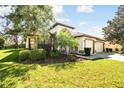 Beautiful home with a lush green lawn and meticulously landscaped garden at 15721 Starling Water Dr, Lithia, FL 33547