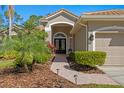 Inviting front entrance with brick walkway and mature landscaping at 18149 Regents Square Dr, Tampa, FL 33647