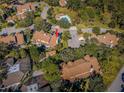 Aerial view of community featuring mature trees, community pool and ample parking at 2180 Clover Hill Rd, Palm Harbor, FL 34683