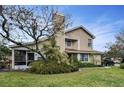 Charming home featuring a meticulously landscaped yard with lush greenery and mature trees at 2180 Clover Hill Rd, Palm Harbor, FL 34683