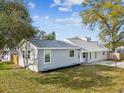 Side view of a single story home with a well-maintained lawn and freshly painted exterior at 2530 Sunset Dr, Largo, FL 33770