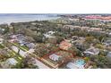 An aerial view of a charming neighborhood with tree-lined streets and a waterfront nearby, showcasing the property's location at 2832 W Bay Haven Dr, Tampa, FL 33611