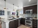 Modern kitchen with stainless steel appliances, marble counters, and stylish pendant lighting at 400 4Th S Ave # 704, St Petersburg, FL 33701