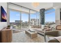 Comfortable living room with large windows offering city views, stylish decor and modern furniture at 400 4Th S Ave # 704, St Petersburg, FL 33701
