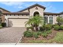 Beautiful single-Gathering home with manicured front yard, garage, and arched entryway at 4016 Cadence Loop, Land O Lakes, FL 34638