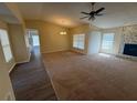 Bright living room features a stone fireplace, ceiling fan, and seamless flow to adjacent rooms at 415 Bloomingfield Dr, Brandon, FL 33511