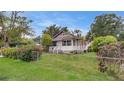 Inviting home boasts lush green lawn, mature trees, and charming curb appeal at 4804 N 10Th St, Tampa, FL 33603