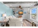 Inviting living room offers comfortable seating, modern entertainment, and scenic waterfront views at 4939 Floramar Ter # 208, New Port Richey, FL 34652