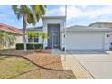 Inviting home with a two-car garage, screened entry and landscaped front yard at 5124 Clover Mist Dr, Apollo Beach, FL 33572