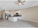 Bright kitchen boasting a large island with black countertops, stainless steel appliances and sleek white cabinetry at 7060 Woodchase Glen Dr, Riverview, FL 33578