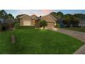Welcoming home with verdant lawn, brick driveway, and classic curb appeal at 10105 Holly Berry Dr, Weeki Wachee, FL 34613
