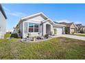 Lovely one-story home with a well-kept lawn, tidy garden beds, and an attached two car garage at 1014 Coastal Hammock Ave, Ruskin, FL 33570
