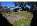 Large fenced backyard features covered patio and ample space for outdoor activities at 13728 1St St, Dade City, FL 33525
