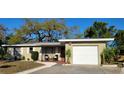 Charming single-story home with a well-maintained lawn, a one car garage, and a cozy front porch at 138 Edgewater Ter, Dunedin, FL 34698