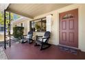 Charming front porch with two rocking chairs and a small table perfect for relaxing with a cool drink at 138 Edgewater Ter, Dunedin, FL 34698