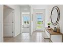 Inviting foyer with stylish console table and a view to the study at 17468 Whiskey Creek Trl, Parrish, FL 34219